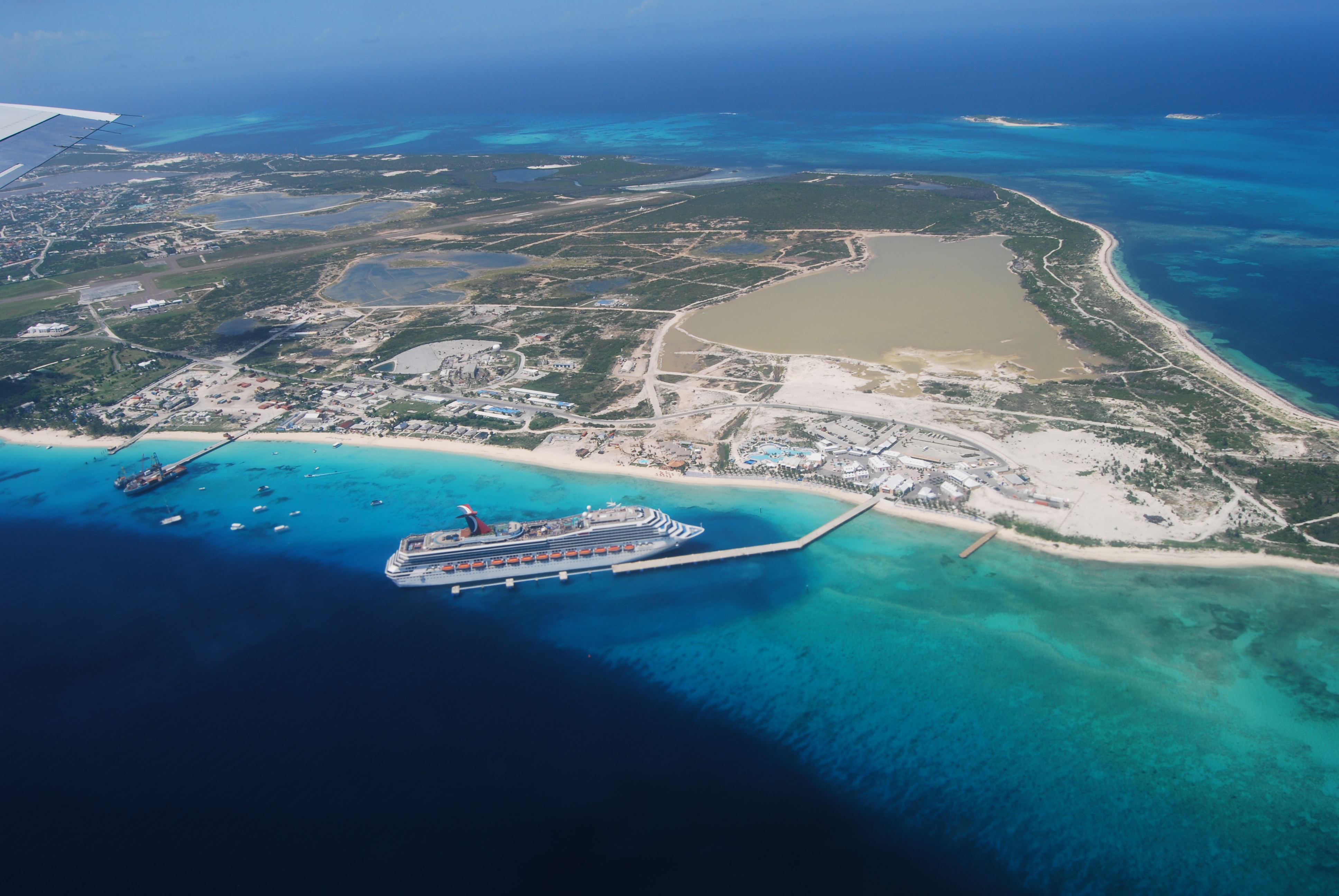 An aerial photo of Grand Turk Island. A cruise ship is in port in the foreground (Copyright: Brian Riggs, DECR)