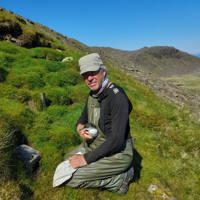 A fieldworker holding a Manx shearwater on Rum