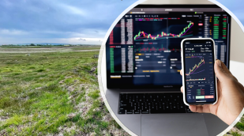 Landscape picture of field in the background with an image of a laptop and phone over the top of it in a circle